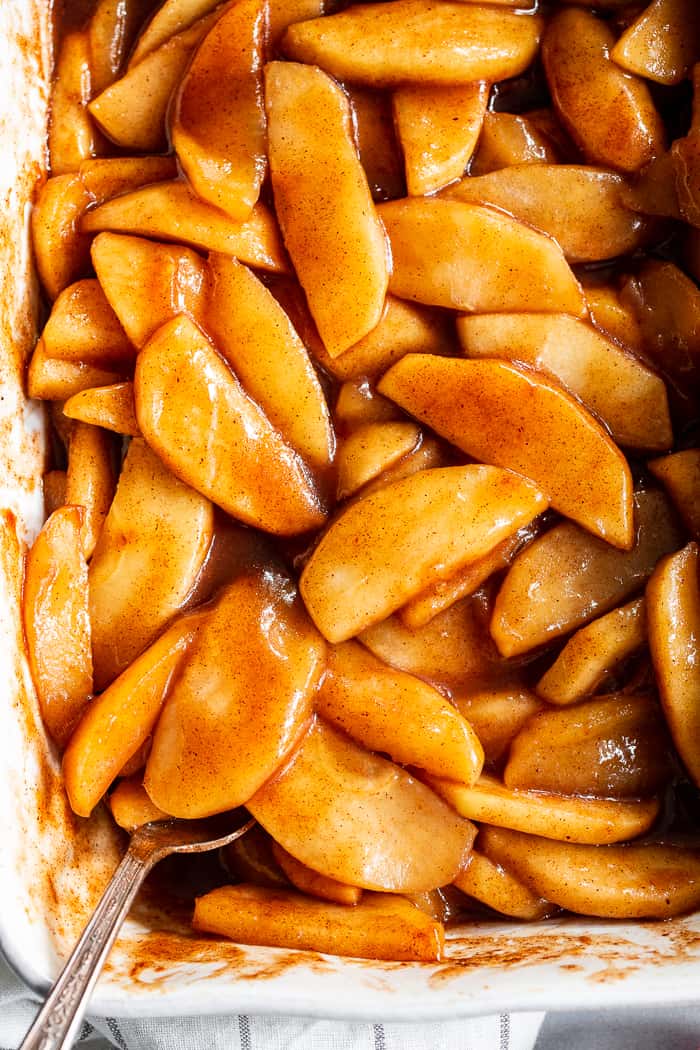 These gooey caramel cinnamon baked apples taste better than apple pie filling with almost no effort at all!  These baked apples are refined sugar free, paleo, vegan, and perfect with a big scoop of coconut vanilla ice cream!