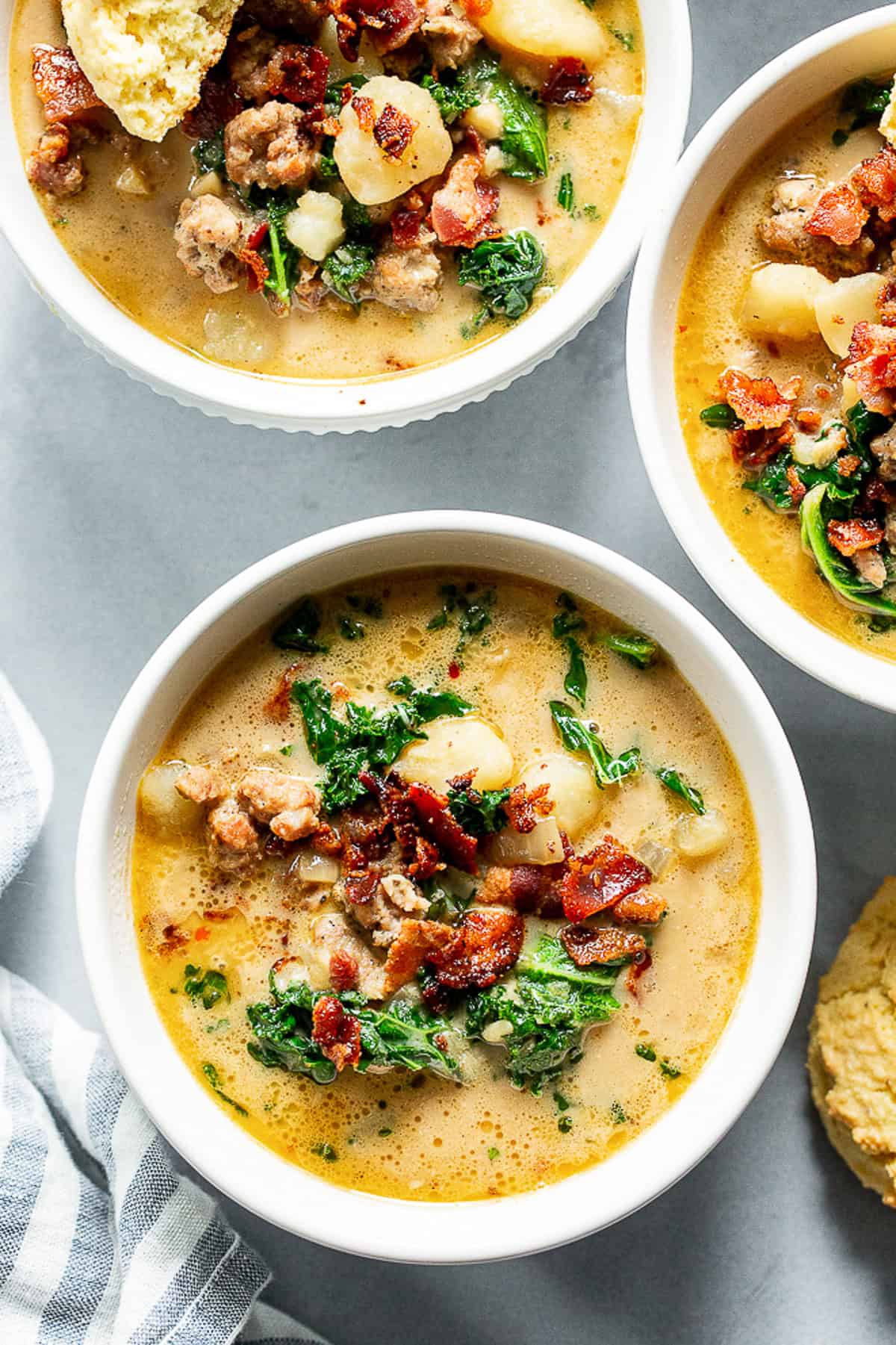 Healthy Zuppa Toscana with Italian sausage, potatoes, kale and crispy bacon in a creamy dairy-free broth