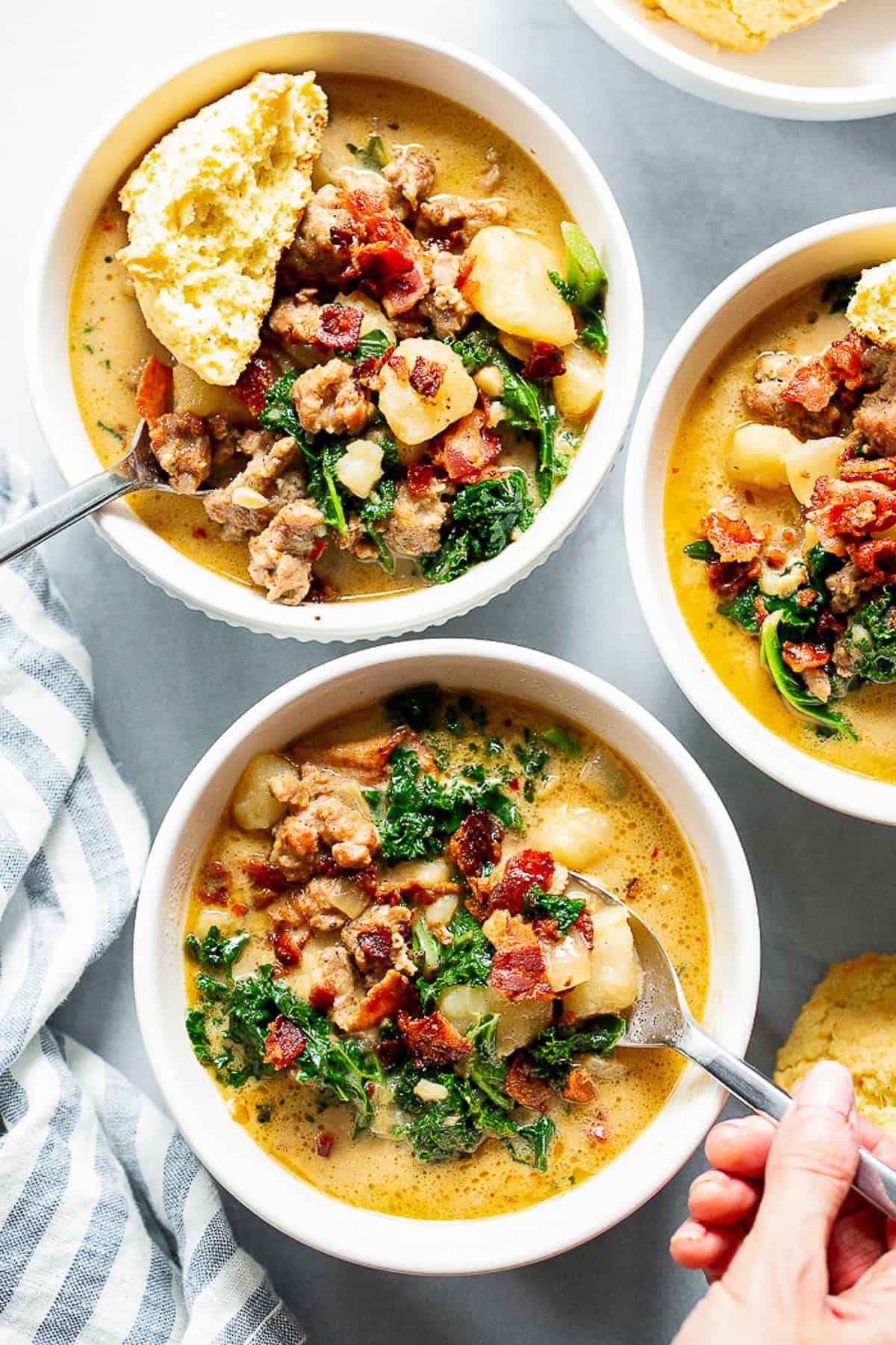 Healthy Zuppa Toscana with Italian sausage, potatoes, kale and crispy bacon in a creamy dairy-free broth