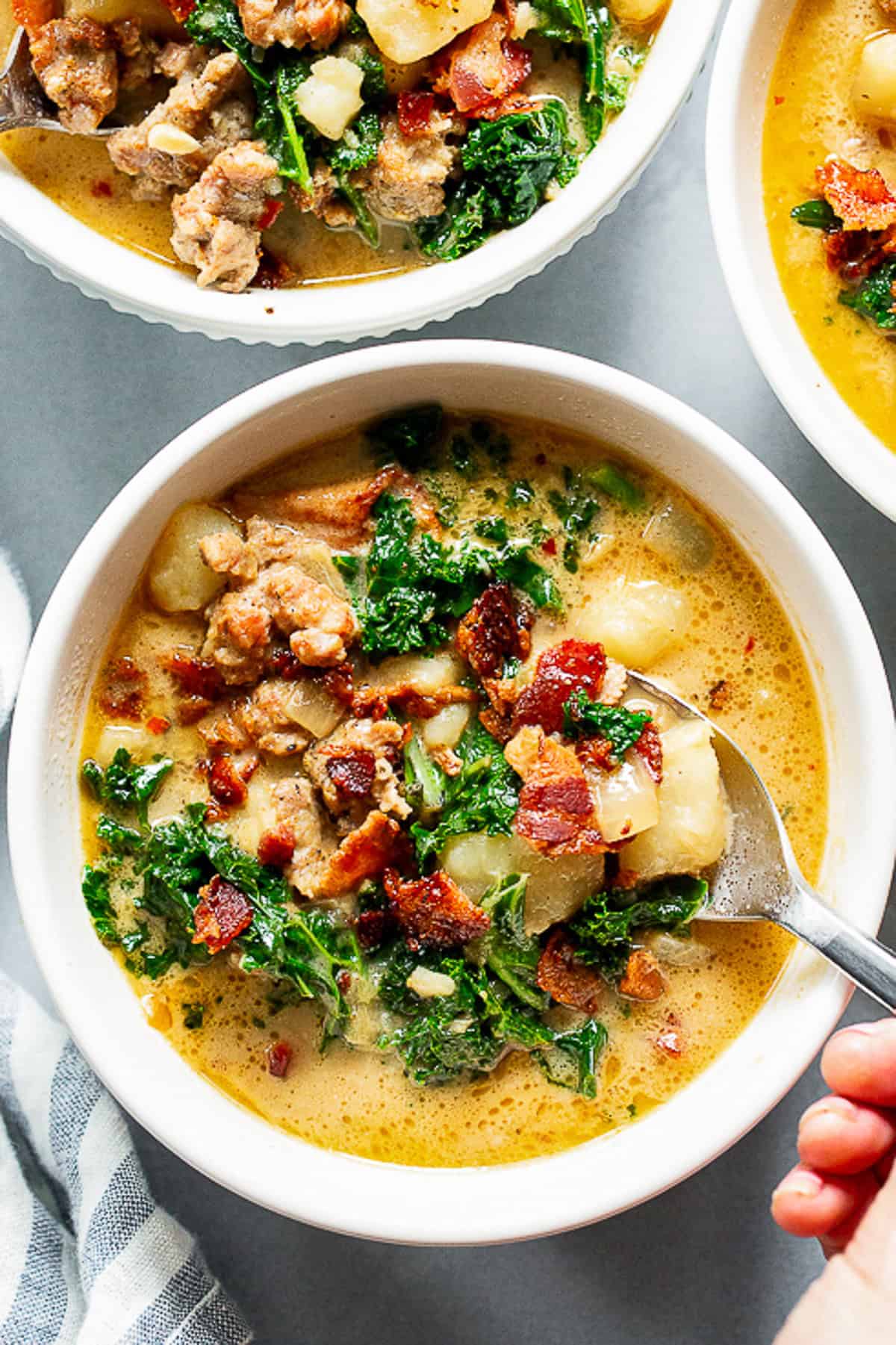 Healthy Zuppa Toscana with Italian sausage, potatoes, kale and crispy bacon in a creamy dairy-free broth