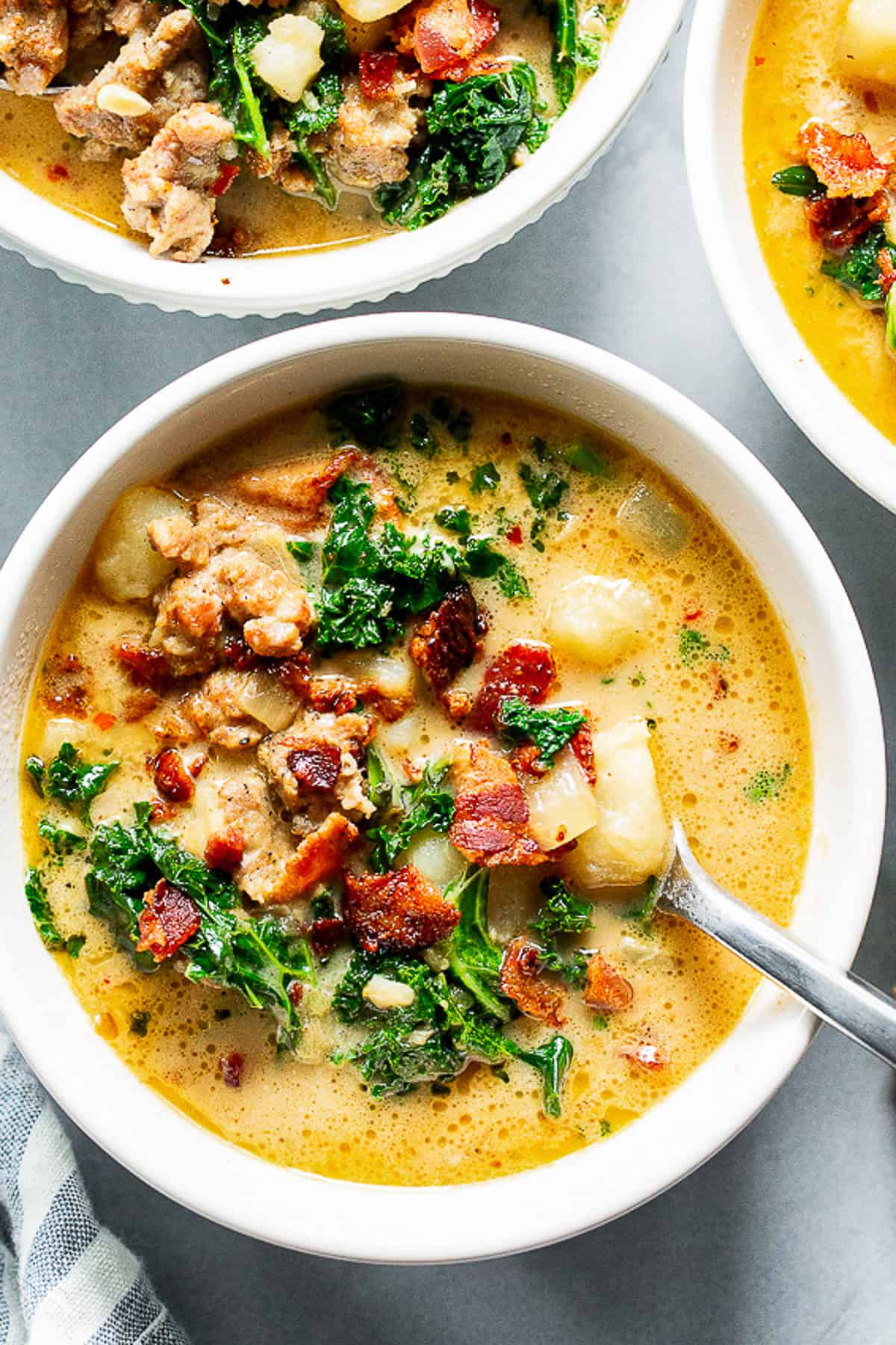 Healthy Zuppa Toscana with Italian sausage, potatoes, kale and crispy bacon in a creamy dairy-free broth