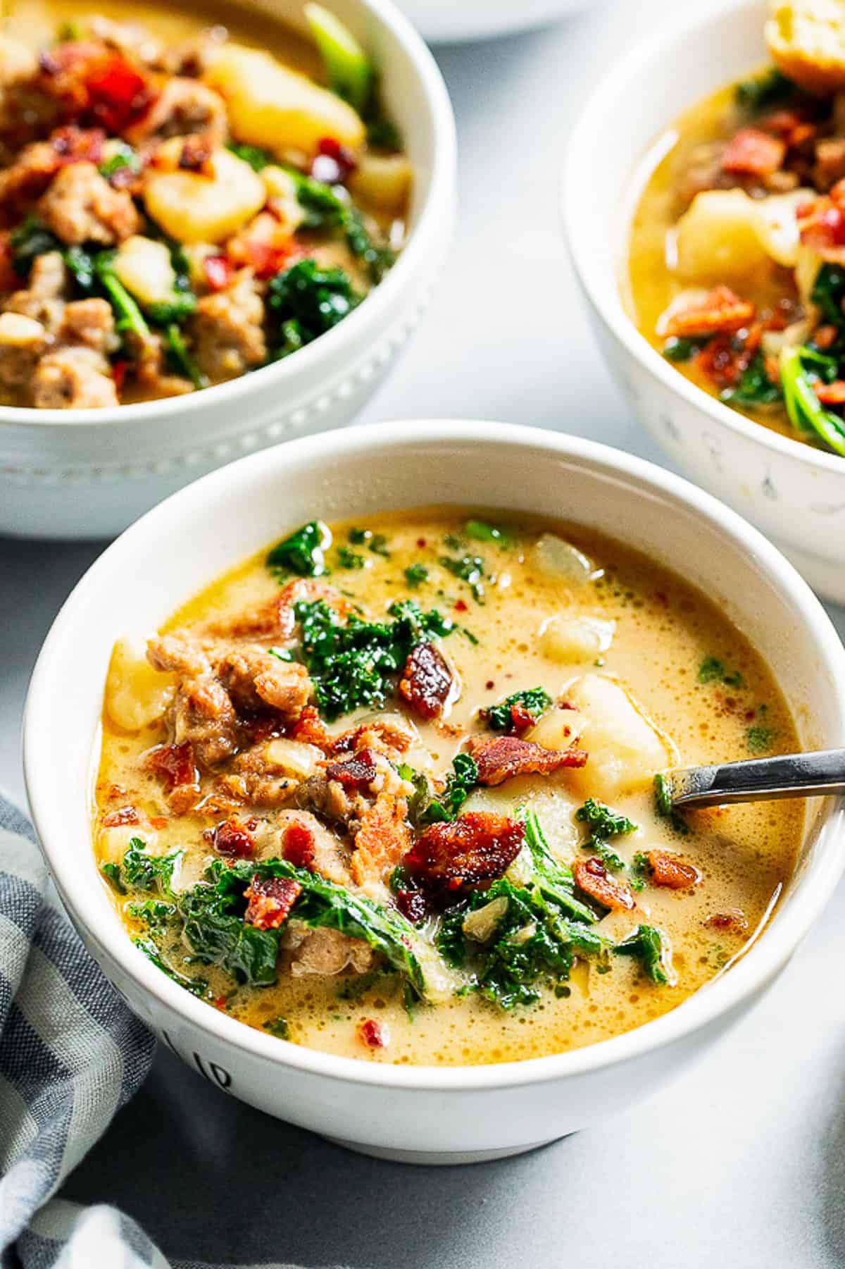 Healthy Zuppa Toscana with Italian sausage, potatoes, kale and crispy bacon in a creamy dairy-free broth