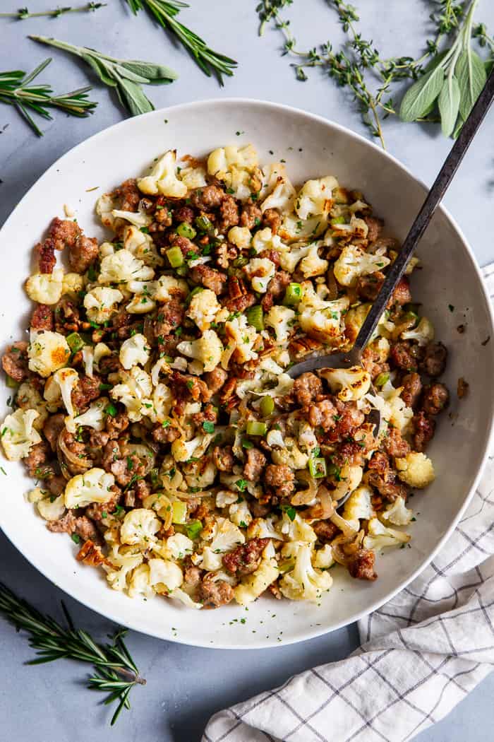 This cauliflower stuffing is packed with goodies like crispy browned sausage, caramelized onions, toasty pecans and savory herbs.  It’s low carb, Whole30 compliant and keto friendly.  It’s sure to be a total showstopper at your holiday table, even for the non-paleo crowd!