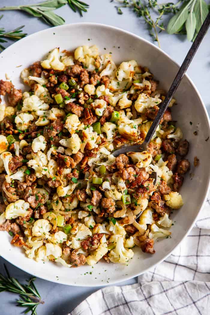 This cauliflower stuffing is packed with goodies like crispy browned sausage, caramelized onions, toasty pecans and savory herbs.  It’s low carb, Whole30 compliant and keto friendly.  It’s sure to be a total showstopper at your holiday table, even for the non-paleo crowd!