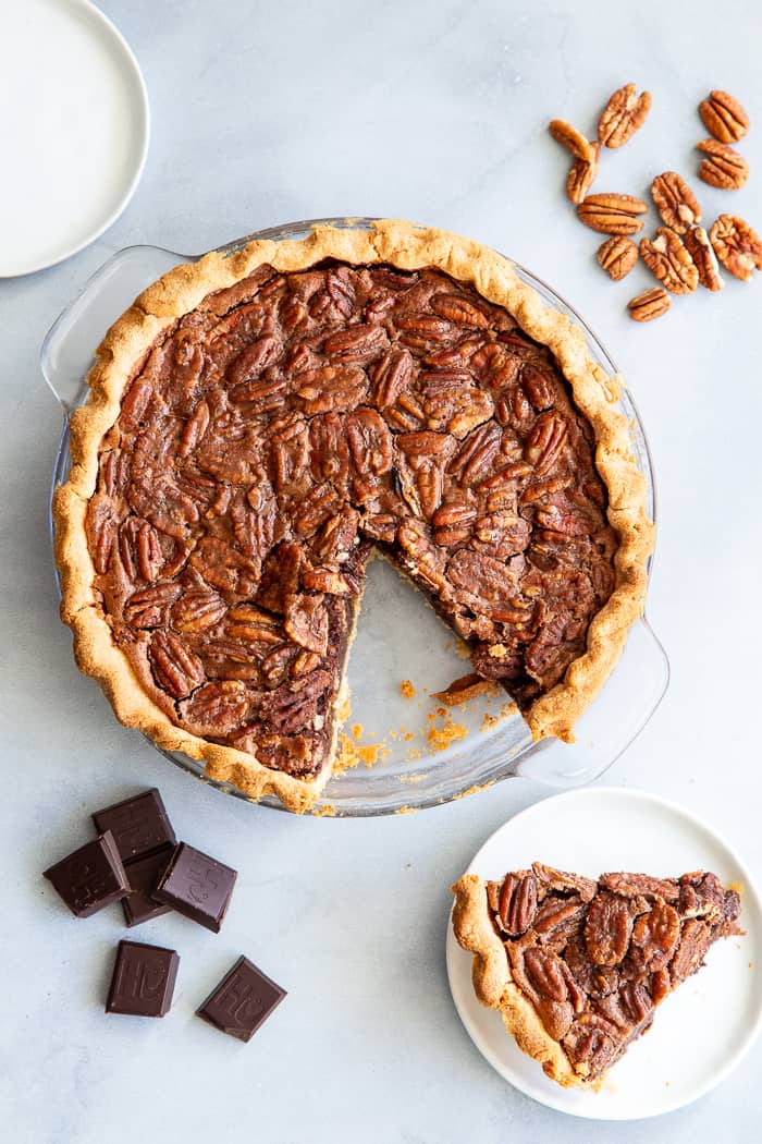 This deliciously rich and gooey chocolate pecan pie is everything you’re craving in a holiday dessert!   Perfect with a big scoop of coconut vanilla ice cream on top, this family favorite is gluten-free, paleo, and dairy-free but no one will know.