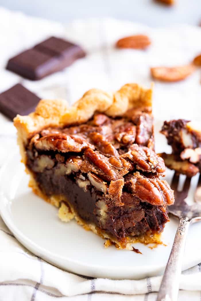 This deliciously rich and gooey chocolate pecan pie is everything you’re craving in a holiday dessert!   Perfect with a big scoop of coconut vanilla ice cream on top, this family favorite is gluten-free, paleo, and dairy-free but no one will know.