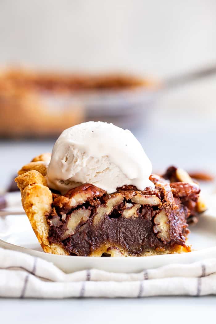 This deliciously rich and gooey chocolate pecan pie is everything you’re craving in a holiday dessert!   Perfect with a big scoop of coconut vanilla ice cream on top, this family favorite is gluten-free, paleo, and dairy-free but no one will know.