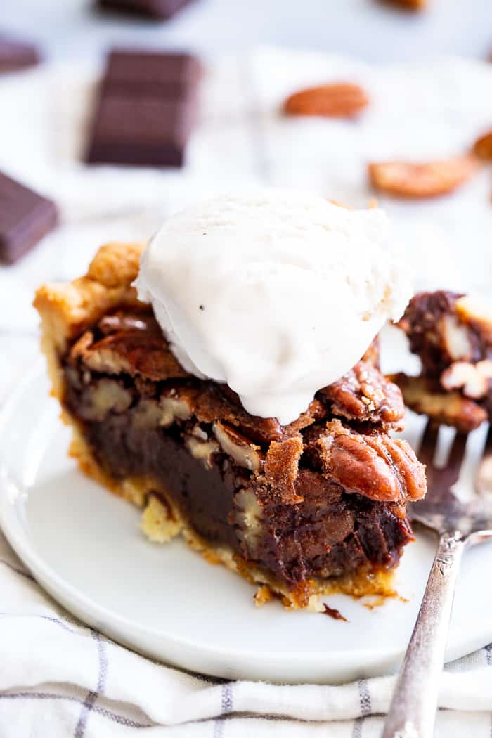 This deliciously rich and gooey chocolate pecan pie is everything you’re craving in a holiday dessert!   Perfect with a big scoop of coconut vanilla ice cream on top, this family favorite is gluten-free, paleo, and dairy-free but no one will know.