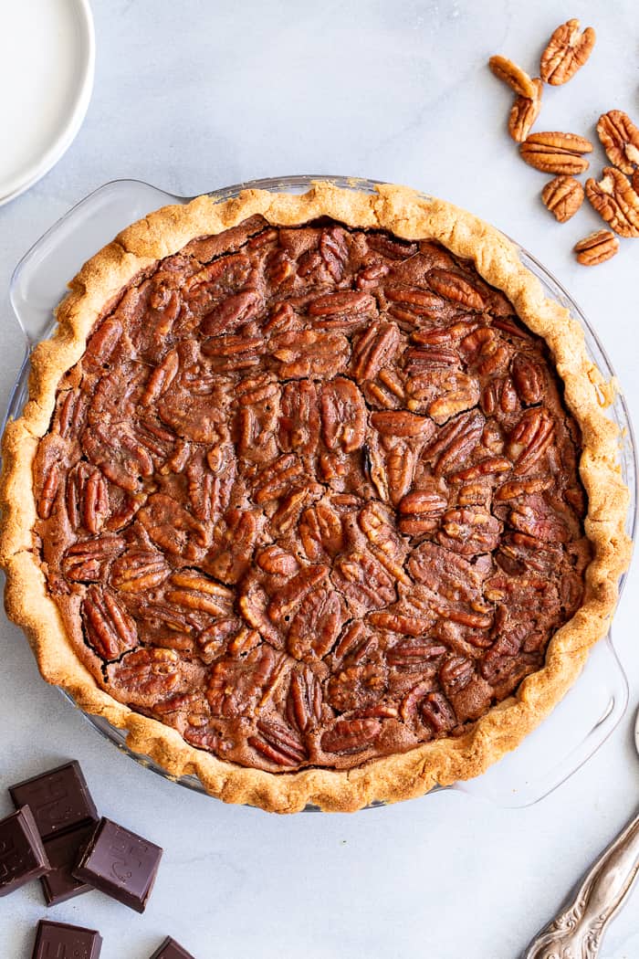 This deliciously rich and gooey chocolate pecan pie is everything you’re craving in a holiday dessert!   Perfect with a big scoop of coconut vanilla ice cream on top, this family favorite is gluten-free, paleo, and dairy-free but no one will know.