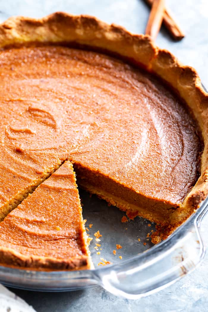 This Paleo Sweet Potato Pie will be a showstopper on your holiday table!  With a grain free and paleo crust that tastes just like the real deal, and a creamy filling filled with sweet warm spices, you’ll be hooked with the first bite.  It’s gluten-free, grain free, refined sugar free, and has a dairy free option.  