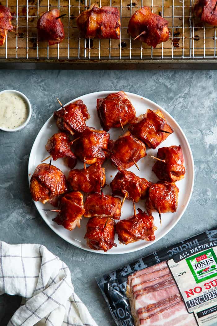 These smoky, savory Bacon Wrapped BBQ Chicken Bites are packed with flavor and easy to make. Zesty chicken bites wrapped in crispy No Sugar All Natural Uncured Hickory Smoked Bacon from @JonesDairyFarm and brushed with lots of Whole30 BBQ sauce. They’re gluten-free, dairy-free, with no added sugar – perfect for parties or anytime you’re craving a savory snack! #AD