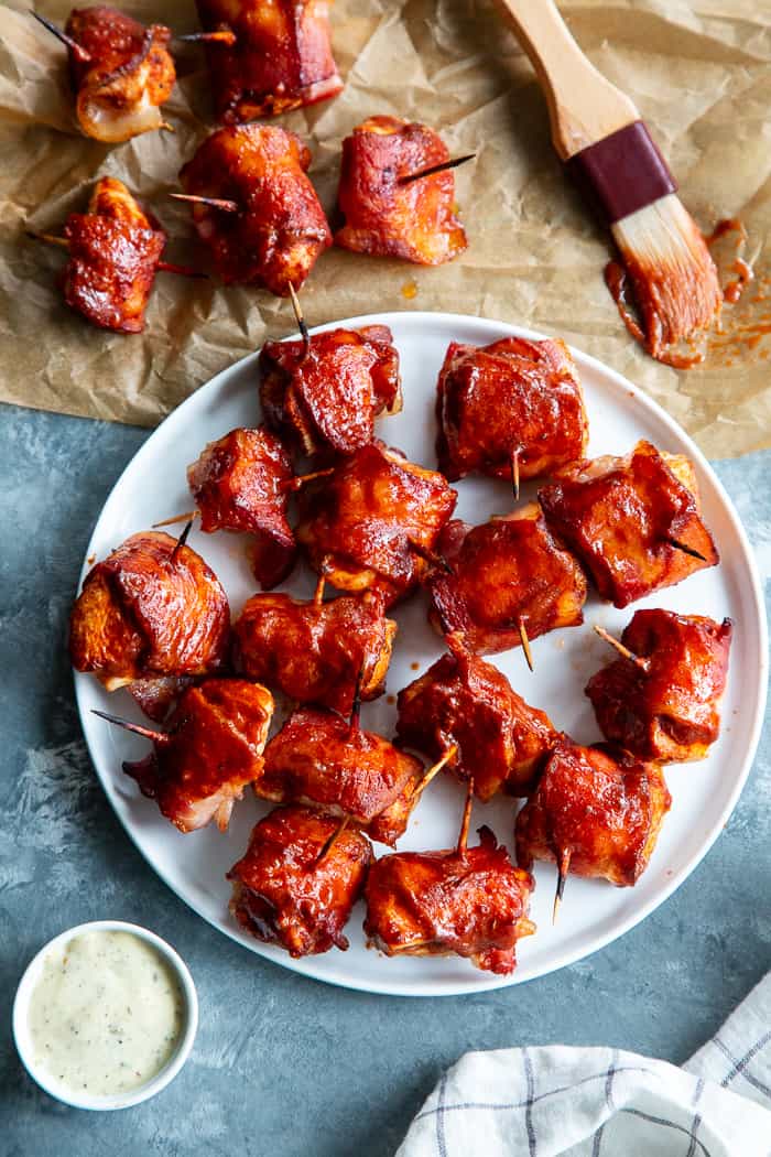 These smoky, savory Bacon Wrapped BBQ Chicken Bites are packed with flavor and easy to make. Zesty chicken bites wrapped in crispy No Sugar All Natural Uncured Hickory Smoked Bacon from @JonesDairyFarm and brushed with lots of Whole30 BBQ sauce. They’re gluten-free, dairy-free, with no added sugar – perfect for parties or anytime you’re craving a savory snack! #AD