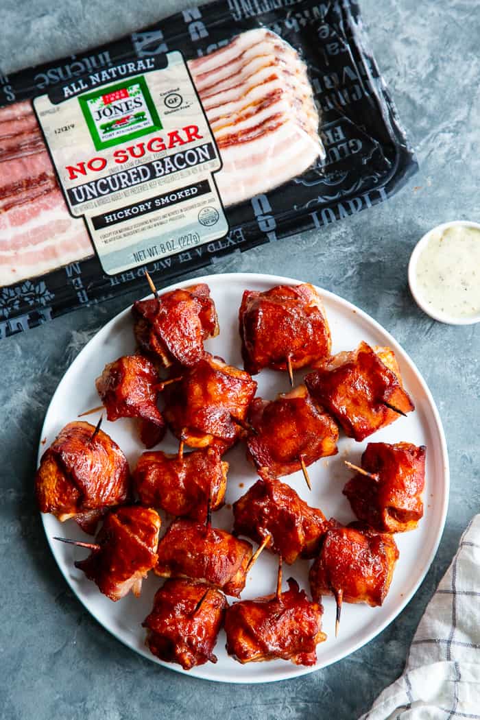 These smoky, savory Bacon Wrapped BBQ Chicken Bites are packed with flavor and easy to make. Zesty chicken bites wrapped in crispy No Sugar All Natural Uncured Hickory Smoked Bacon from @JonesDairyFarm and brushed with lots of Whole30 BBQ sauce. They’re gluten-free, dairy-free, with no added sugar – perfect for parties or anytime you’re craving a savory snack! #AD