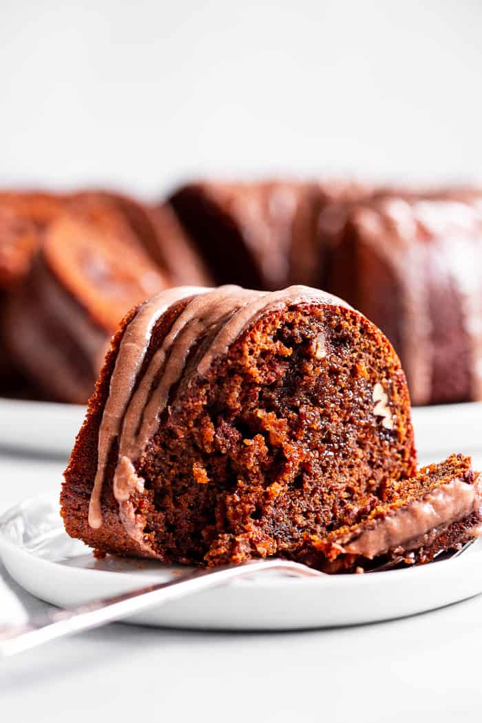 This grain free and paleo Gingerbread Bundt Cake is moist and tender, with a sweet cinnamon maple pecan swirl!  Topped with a sweet maple glaze, this gluten-free, dairy-free cake is sure to be a favorite for the holiday season!