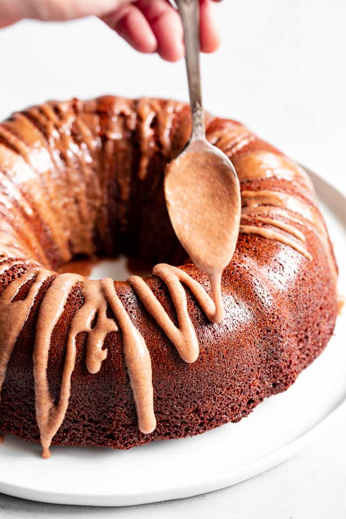 This grain free and paleo Gingerbread Bundt Cake is moist and tender, with a sweet cinnamon maple pecan swirl!  Topped with a sweet maple glaze, this gluten-free, dairy-free cake is sure to be a favorite for the holiday season!