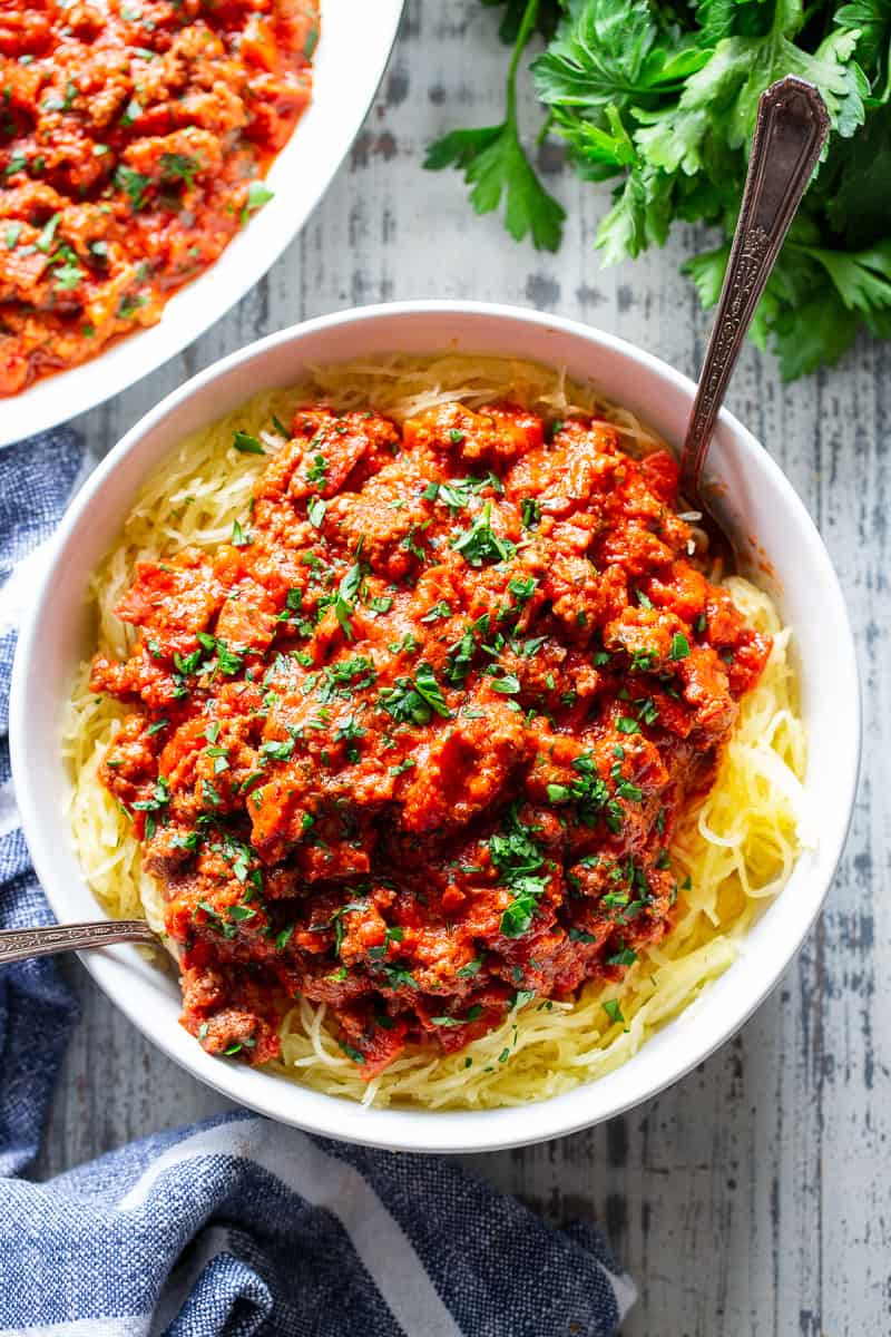 This easy spaghetti squash bolognese is great for healthy weeknight dinners with a flavorful meat sauce and perfectly roasted “al dente” spaghetti squash!  It’s dairy-free, Whole30 compliant, paleo, gluten free and Low FODMAP too. #paleo #cleaneating #gutfriendly #SIBO