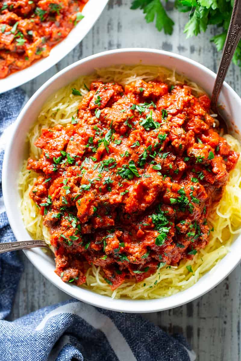 This easy spaghetti squash bolognese is great for healthy weeknight dinners with a flavorful meat sauce and perfectly roasted “al dente” spaghetti squash!  It’s dairy-free, Whole30 compliant, paleo, gluten free and Low FODMAP too. #paleo #cleaneating #gutfriendly #SIBO