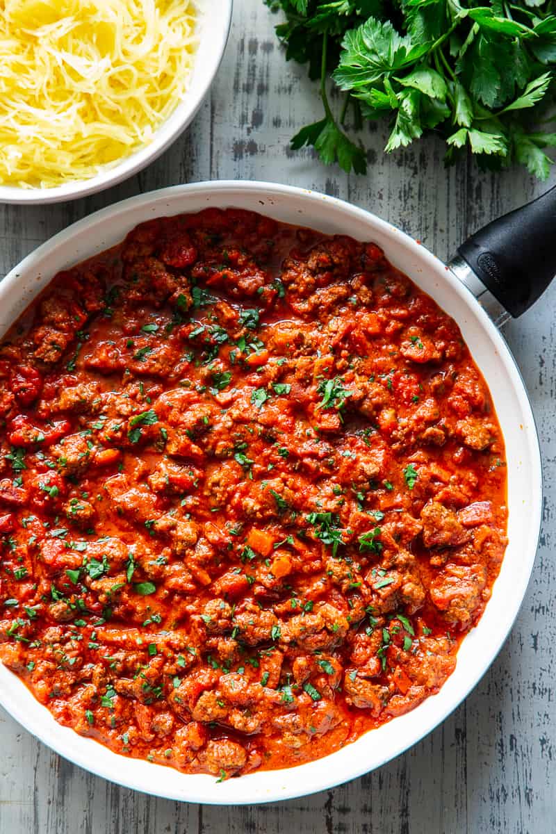 This easy spaghetti squash bolognese is great for healthy weeknight dinners with a flavorful meat sauce and perfectly roasted “al dente” spaghetti squash!  It’s dairy-free, Whole30 compliant, paleo, gluten free and Low FODMAP too. #paleo #cleaneating #gutfriendly #SIBO