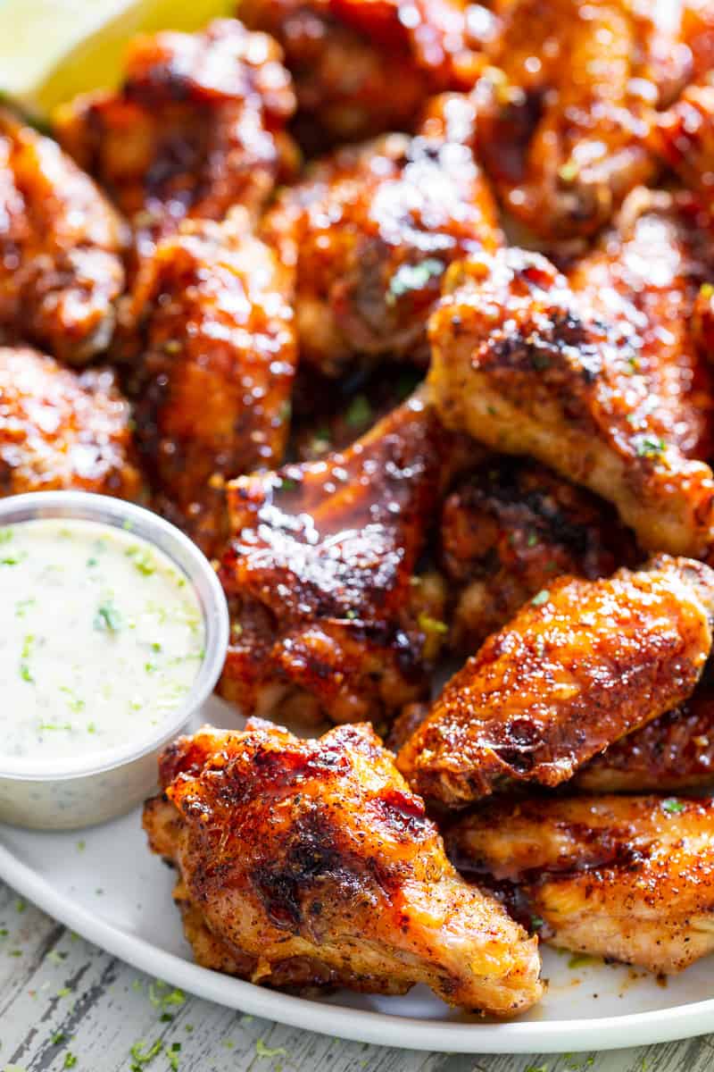 These sweet and spicy chili lime chicken wings are packed with flavor and perfect for parties, appetizers or a fun dinner!  These crispy baked chicken wings are paleo with a Whole30 option to sweeten the sauce, family friendly and a total crowd pleaser. #Paleo #cleaneating #wings #whole30 #superbowl