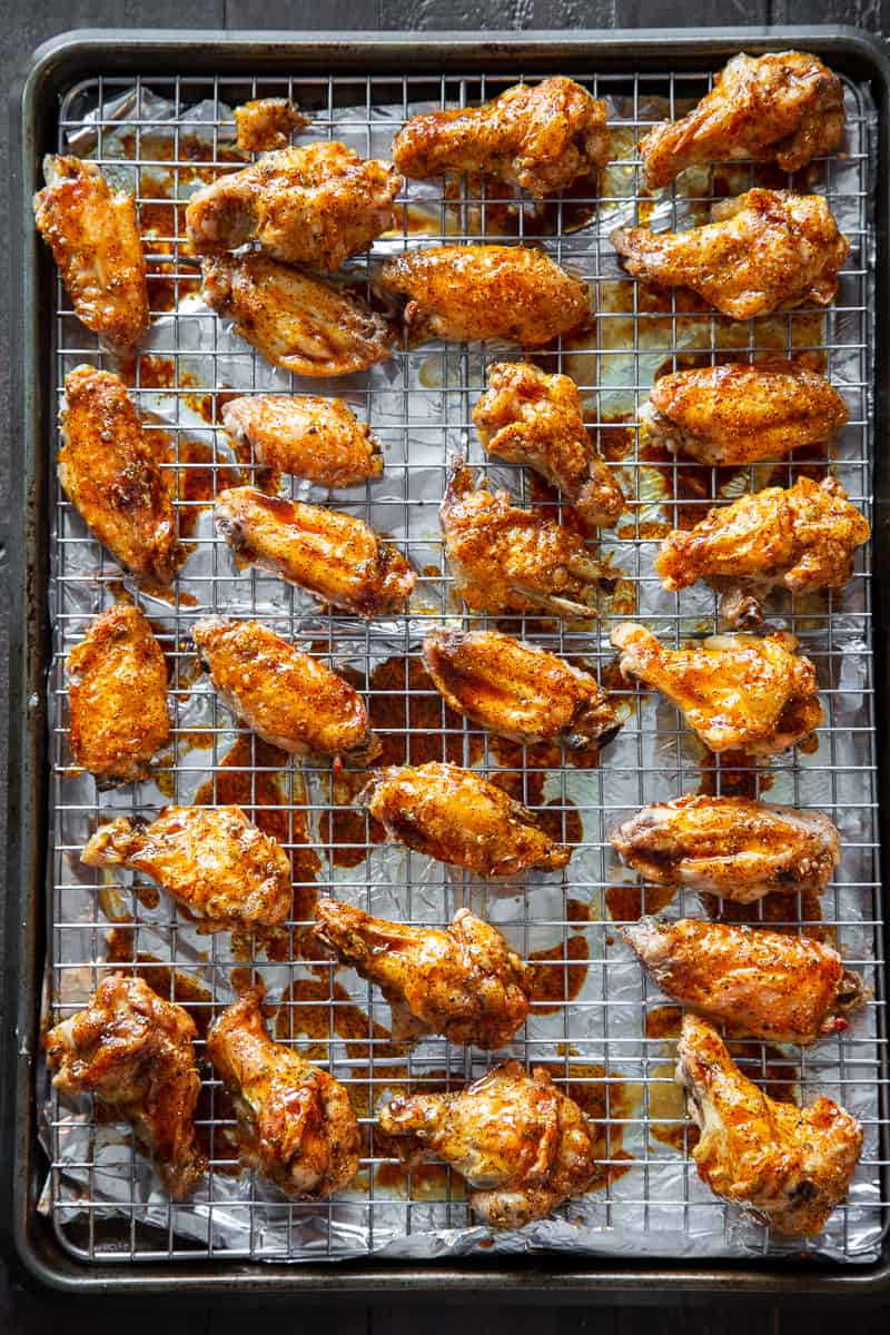 These sweet and spicy chili lime chicken wings are packed with flavor and perfect for parties, appetizers or a fun dinner!  These crispy baked chicken wings are paleo with a Whole30 option to sweeten the sauce, family friendly and a total crowd pleaser. #Paleo #cleaneating #wings #whole30 #superbowl
