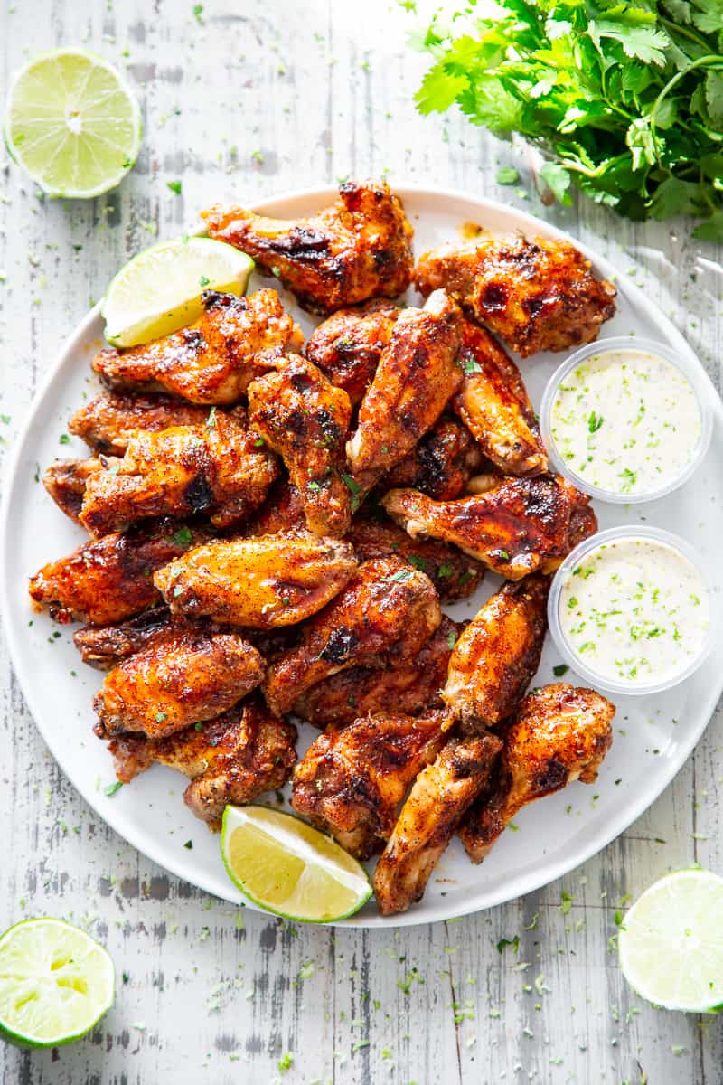 These sweet and spicy chili lime chicken wings are packed with flavor and perfect for parties, appetizers or a fun dinner!  These crispy baked chicken wings are paleo with a Whole30 option to sweeten the sauce, family friendly and a total crowd pleaser. #Paleo #cleaneating #wings #whole30 #superbowl