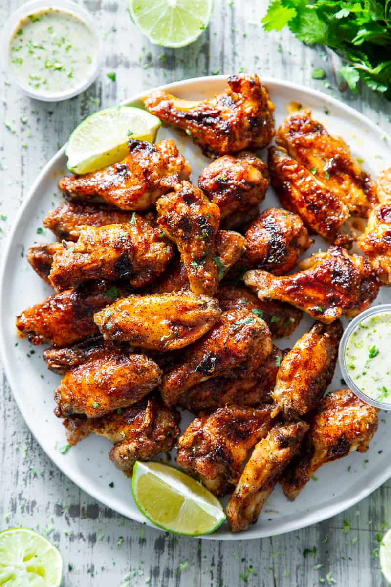 These sweet and spicy chili lime chicken wings are packed with flavor and perfect for parties, appetizers or a fun dinner!  These crispy baked chicken wings are paleo with a Whole30 option to sweeten the sauce, family friendly and a total crowd pleaser. #Paleo #cleaneating #wings #whole30 #superbowl