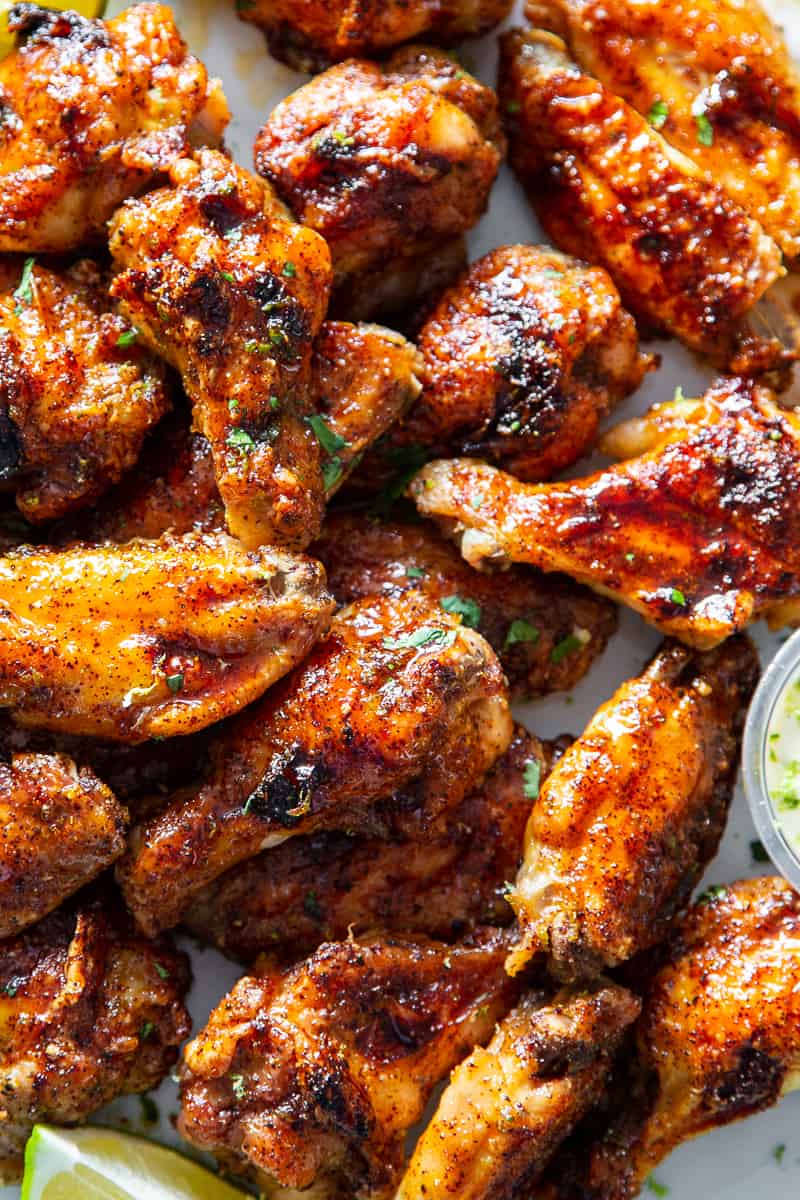 These sweet and spicy chili lime chicken wings are packed with flavor and perfect for parties, appetizers or a fun dinner!  These crispy baked chicken wings are paleo with a Whole30 option to sweeten the sauce, family friendly and a total crowd pleaser. #Paleo #cleaneating #wings #whole30 #superbowl