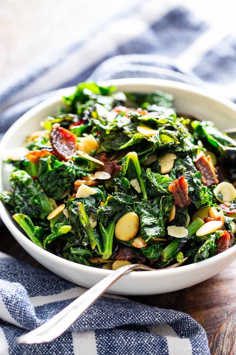 This delicious and simple sautéed kale with bacon and almonds is a savory healthy side dish that you’ll want on repeat!  It’s paleo and Whole30 friendly, keto, and Low FODMAP.  Serve it with any main course to add lots of flavor and nutrients to your meal.