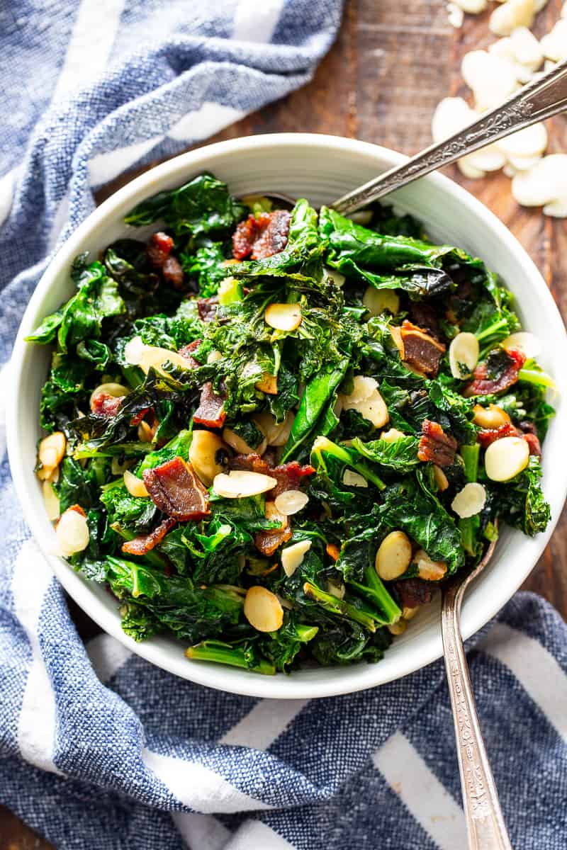 This delicious and simple sautéed kale with bacon and almonds is a savory healthy side dish that you’ll want on repeat!  It’s paleo and Whole30 friendly, keto, and Low FODMAP.  Serve it with any main course to add lots of flavor and nutrients to your meal. #keto #cleaneating #paleo #whole30 #lowfodmap