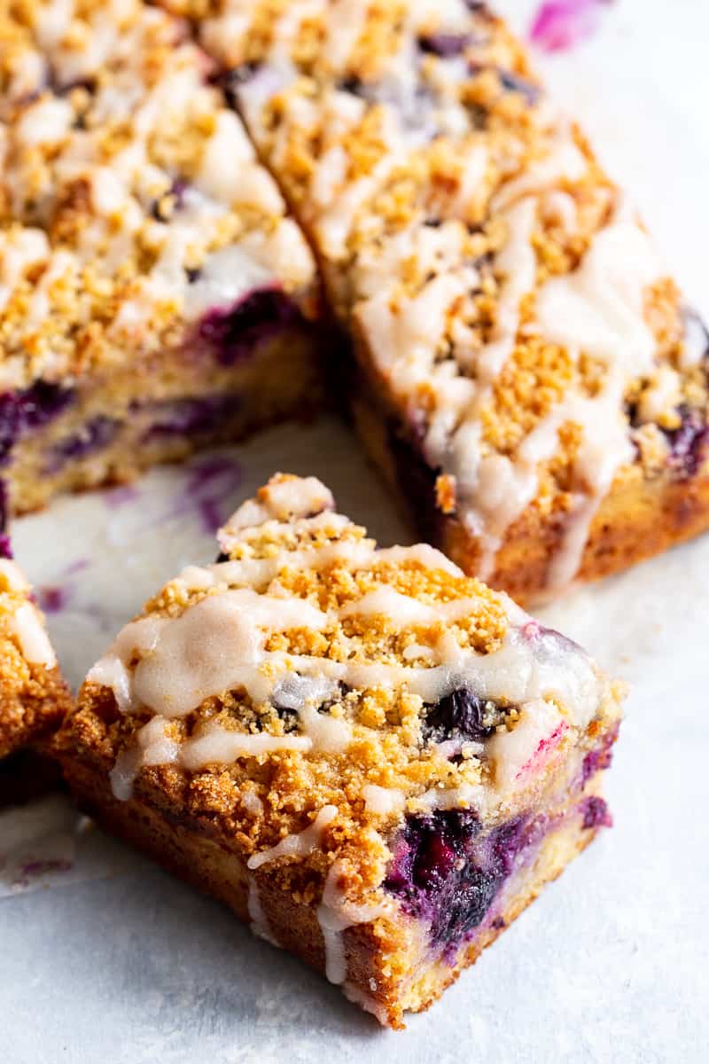 This Lemon Blueberry Coffee Cake is bursting with fresh lemon flavor and juicy blueberries!  It starts with a  perfectly moist lemon almond cake layer with fresh blueberries piled with crumb topping and drizzled with lemon glaze.  It’s gluten-free and paleo and will become a favorite dessert or breakfast treat with the first bite!  #cleaneating #paleo #kingarthurflour @kingarthurflour #AD