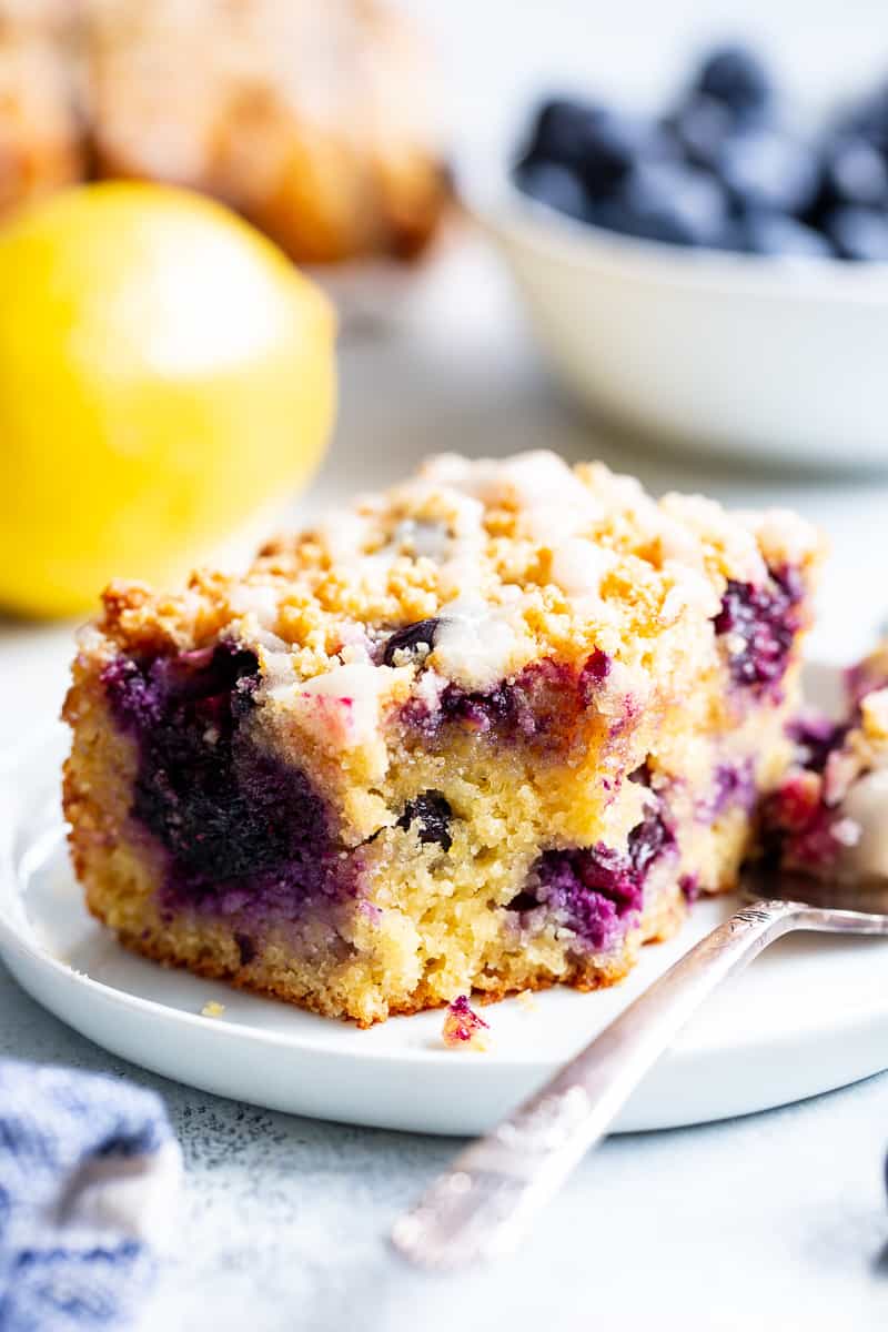 This Lemon Blueberry Coffee Cake is bursting with fresh lemon flavor and juicy blueberries!  It starts with a  perfectly moist lemon almond cake layer with fresh blueberries piled with crumb topping and drizzled with lemon glaze.  It’s gluten-free and paleo and will become a favorite dessert or breakfast treat with the first bite!  #cleaneating #paleo #kingarthurflour @kingarthurflour #AD