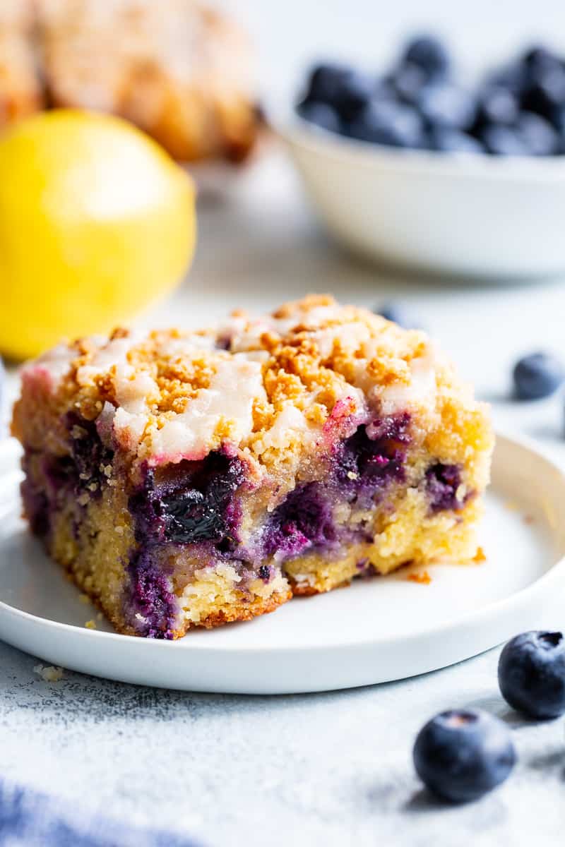 This Lemon Blueberry Coffee Cake is bursting with fresh lemon flavor and juicy blueberries!  It starts with a  perfectly moist lemon almond cake layer with fresh blueberries piled with crumb topping and drizzled with lemon glaze.  It’s gluten-free and paleo and will become a favorite dessert or breakfast treat with the first bite!  #cleaneating #paleo #kingarthurflour @kingarthurflour #AD