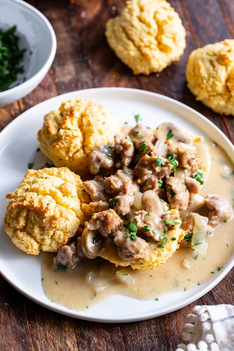 Easy to make, quick and healthy mushroom sausage gravy with paleo and keto friendly biscuits. This meal is great anytime you’re craving savory, hearty comfort food. Gluten free, dairy free, sugar free. 