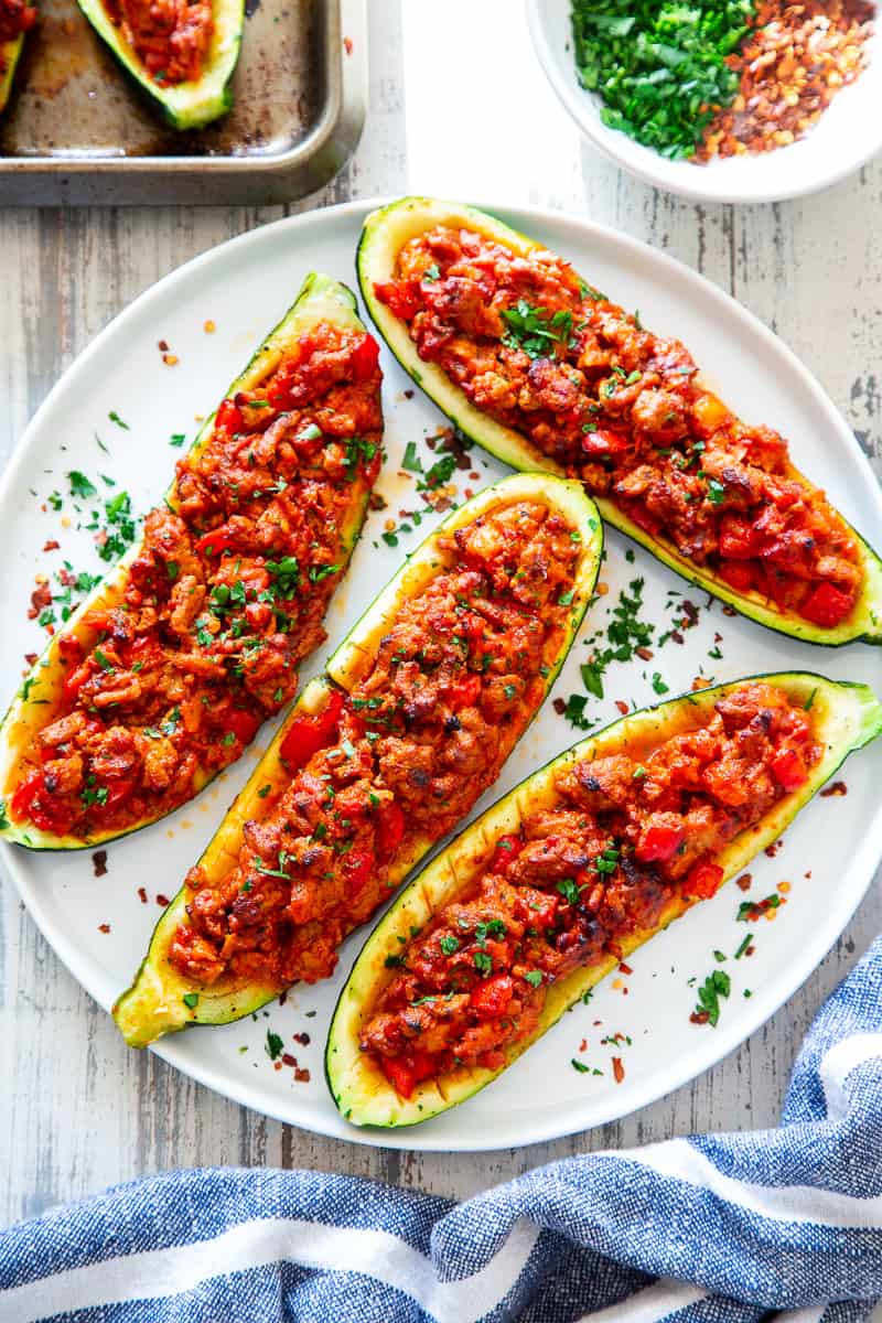 These hearty Italian Zucchini Boats are flavor packed and make a quick, healthy and fun dinner!   They're also perfect to meal prep ahead of time for busy nights and are totally dairy-free, grain free, keto, paleo and Whole30 compliant, and Low FODMAP. #cleaneating #lowFODMAP #keto #paleo