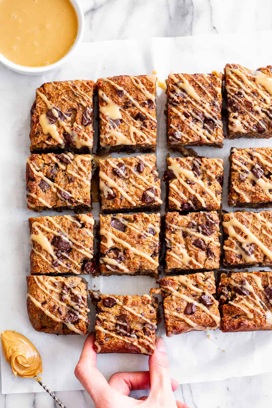 These one-bowl almond butter banana bread bars are a simple and totally delicious treat to make any time!  Great for snacks and dessert, they’re packed with good fats, banana flavor and dark chocolate.  Top them with an almond butter icing to take them to the next level!  Vegan, paleo, refined sugar free, egg free. #vegan #paleo #glutenfree