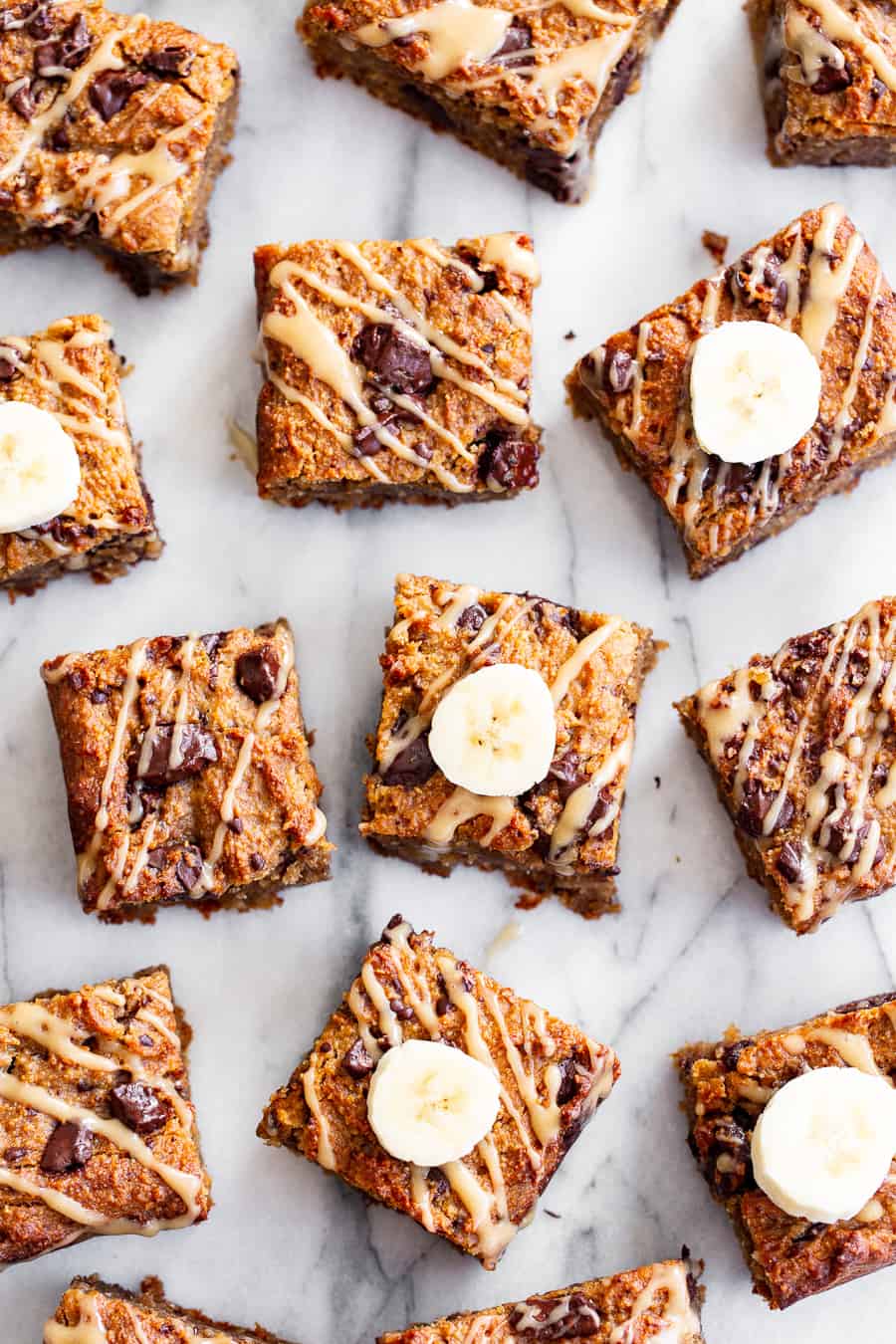 These one-bowl almond butter banana bread bars are a simple and totally delicious treat to make any time!  Great for snacks and dessert, they’re packed with good fats, banana flavor and dark chocolate.  Top them with an almond butter icing to take them to the next level!  Vegan, paleo, refined sugar free, egg free. #paleo #vegan #glutenfree