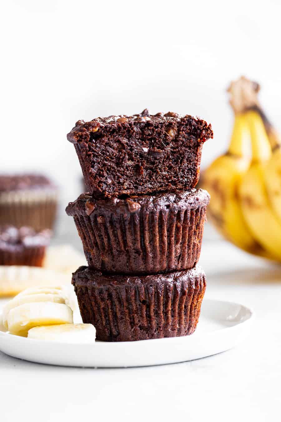 These moist and tender double chocolate banana muffins are quick and easy to make and taste just as decadent as rich chocolate cupcakes!  Made with coconut flour and raw cacao powder so they’re paleo plus nut free, gluten free, and dairy free.  Kid approved and great for snacks and dessert! #paleorecipes #bananamuffins #paleo #paleobaking #glutenfree #coconutflour