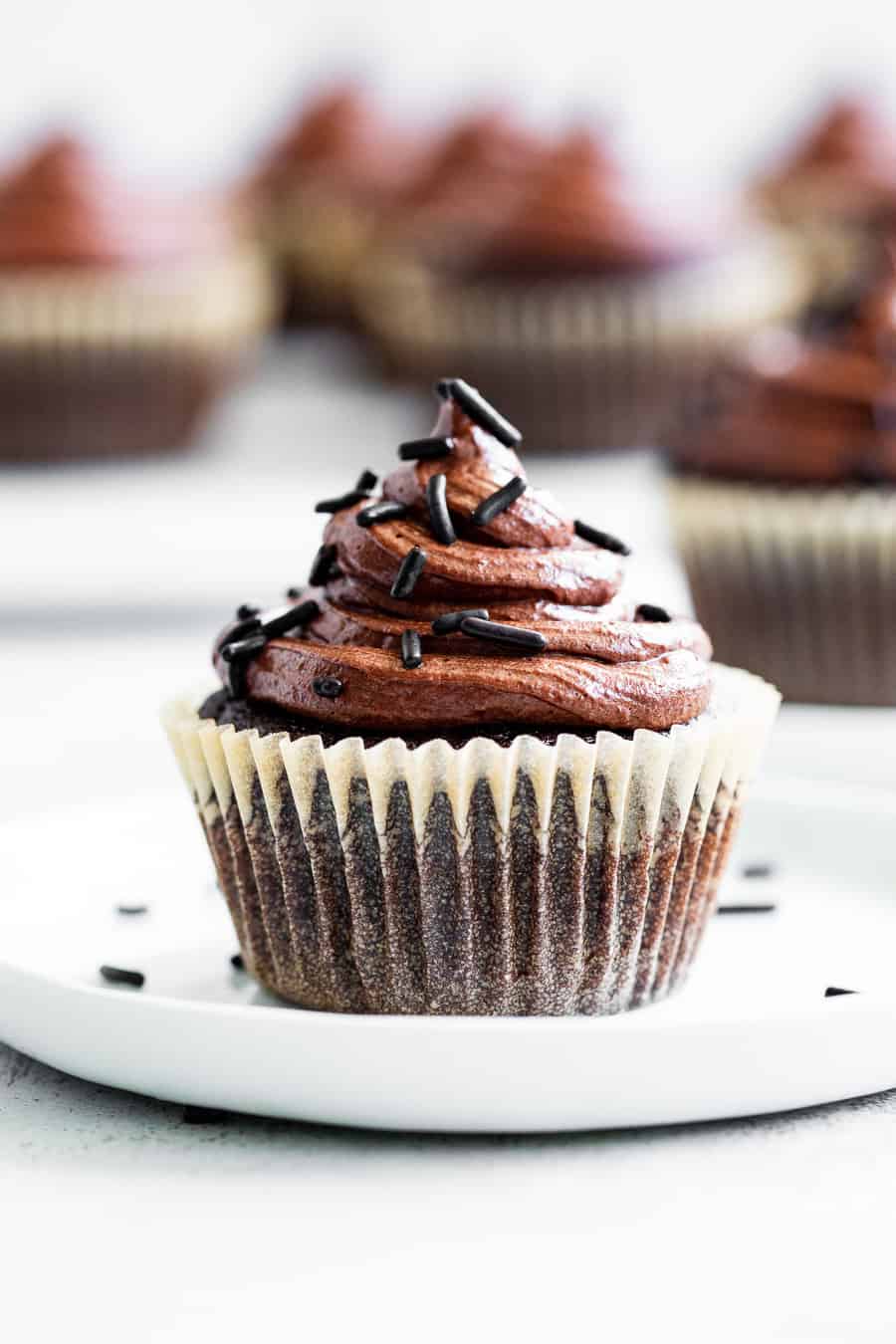 These paleo chocolate cupcakes are perfectly tender, moist and rich with a dairy-free buttercream frosting that tastes just like the real deal!  They’re gluten free, dairy free and nut free and kid approved.  Great for birthdays, holidays or simply because you're craving chocolate! #healthydessert #paleo #glutenfree