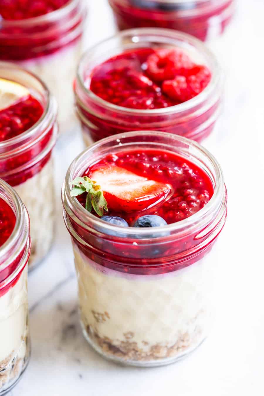 These fun single serve no bake cheesecake jars are made with real food ingredients and are completely dairy and soy free!  They’re perfect to make ahead of time for an easy and delicious healthy dessert you can grab anytime.  Kid friendly, paleo, vegan, and easy to make. #vegan #paleo #cheesecake #healthydessert