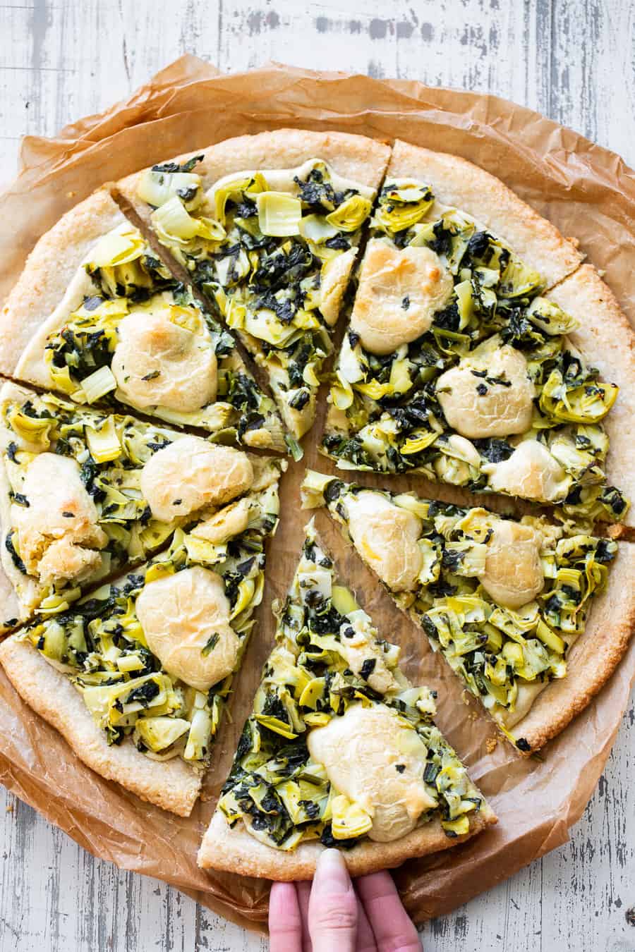 This Spinach Artichoke Pizza has the perfect one-bowl chewy crust and is topped with the best homemade cashew cheese plus a savory spinach artichoke mixture! Paleo, Vegan, gluten free, dairy free, egg free and sugar free. #paleo #Vegan #glutenfree #pizza #dairyfree