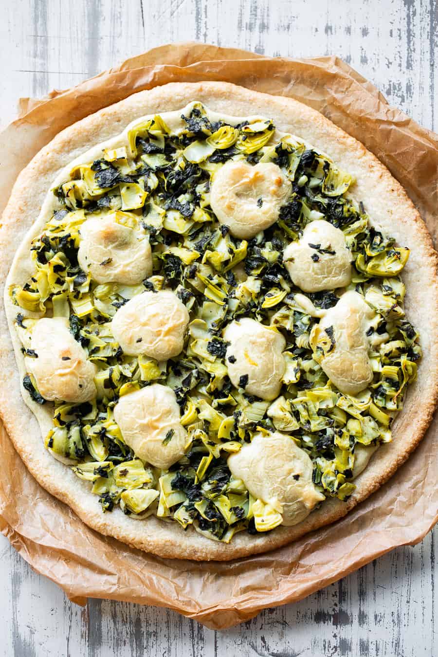 This Spinach Artichoke Pizza has the perfect one-bowl chewy crust and is topped with the best homemade cashew cheese plus a savory spinach artichoke mixture! Paleo, Vegan, gluten free, dairy free, egg free and sugar free. #paleo #Vegan #glutenfree #pizza #dairyfree