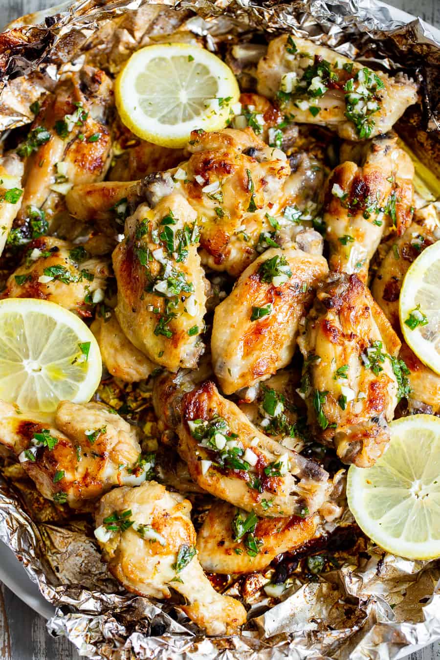These delicious, grilled chicken wings have an easy sauce with lots of bright lemon, savory garlic, and fresh herbs and go perfectly with all your favorite potato salads and summer sides!  These flavor-packed wings are Whole30 compliant, paleo, keto, and dairy-free.  