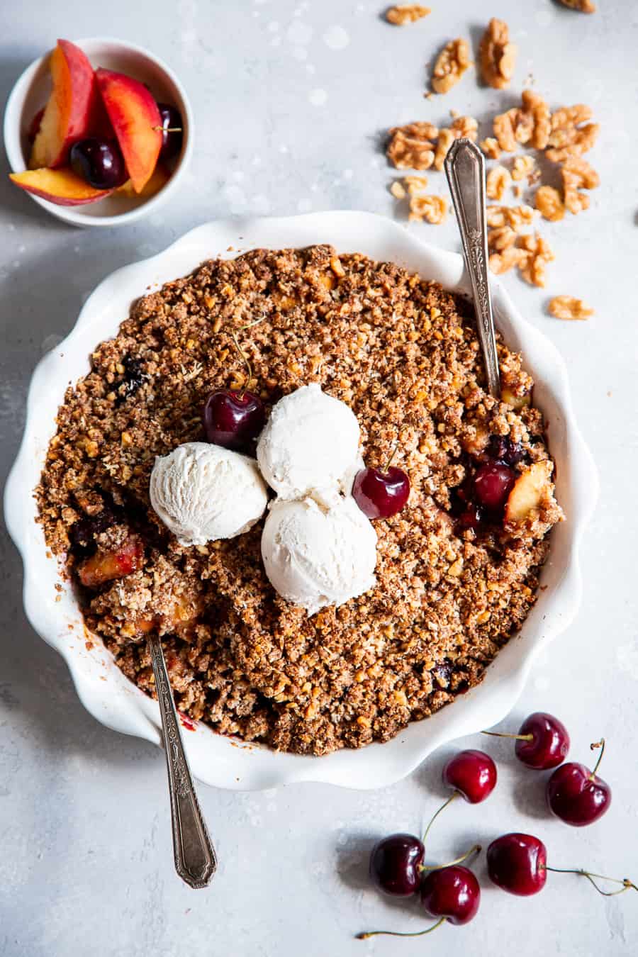 This cherry and peach crisp is irresistibly delicious and easy to make!  A sweet gooey peach and cherry filling is topped with a toasty crumble for a summer dessert that will make everyone come back for seconds.  It’s paleo, vegan, gluten-free, dairy-free and refined sugar free. #vegan #paleo #cleaneating #paleodessert