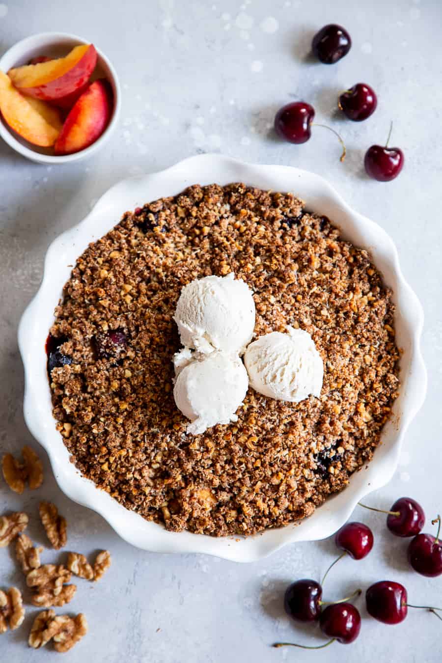 This cherry and peach crisp is irresistibly delicious and easy to make!  A sweet gooey peach and cherry filling is topped with a toasty crumble for a summer dessert that will make everyone come back for seconds.  It’s paleo, vegan, gluten-free, dairy-free and refined sugar free. #vegan #paleo #cleaneating #paleodessert
