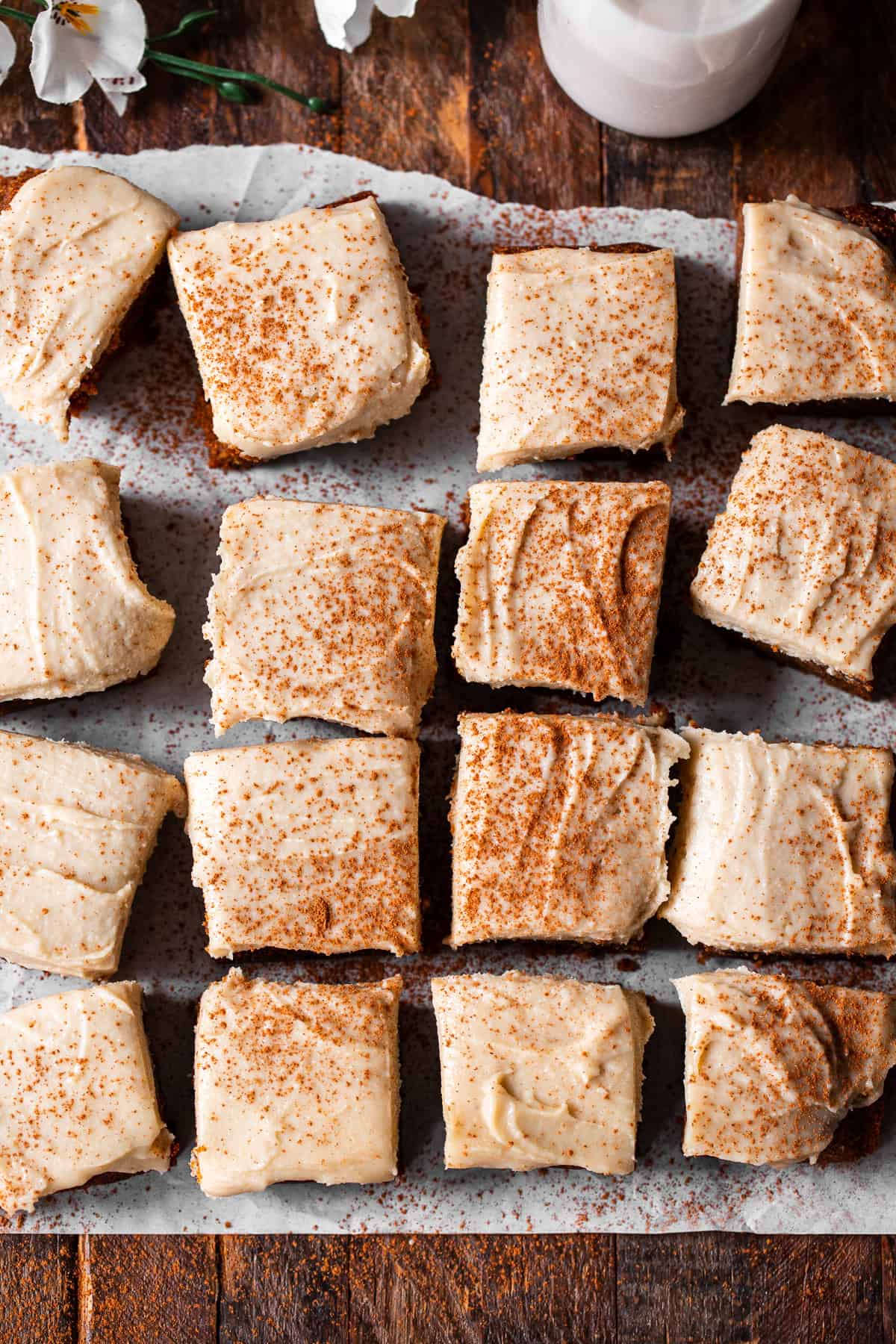 Paleo pumpkin bars with dairy-free cream cheese frosting cut into squares
