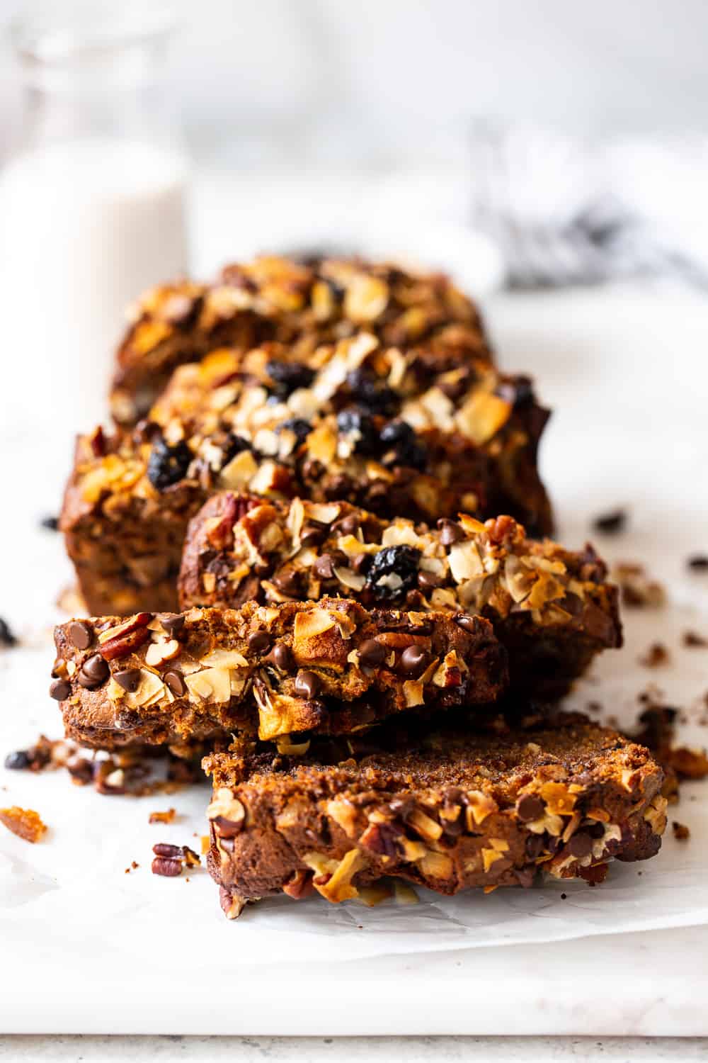 This grain free trail mix bread is a fun twist on a simple paleo quick bread! It’s loaded with warm spices, dried fruit, nuts and coconut, and sweetened with maple syrup and coconut sugar. It’s perfect to slather with nut butter for breakfast or for an anytime snack! Gluten free, refined sugar free, paleo, dairy free. #paleo #glutenfree #paleobaking #cleaneating 