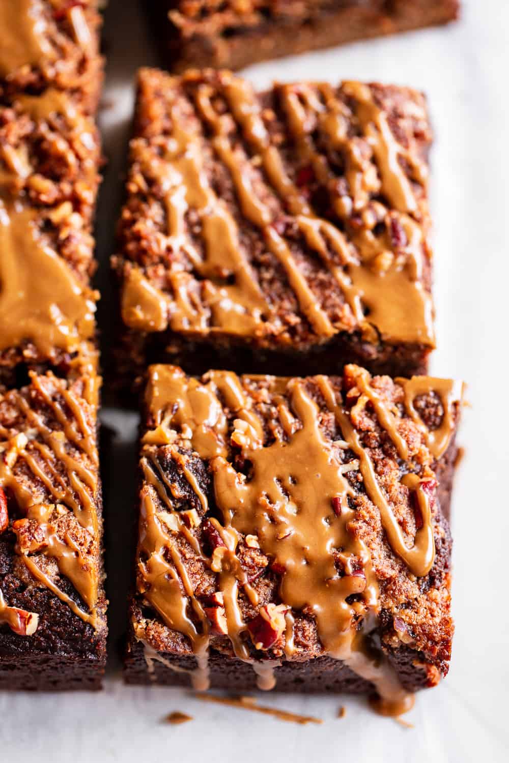 This Paleo Pumpkin Gingerbread Coffee Cake has it all!  Moist cake with sweet warm pumpkin spices and molasses topped with an addicting crumb topping and gingerbread icing!  Fancy enough to serve to guests but so delicious that you’ll want to have some to snack on all season long.