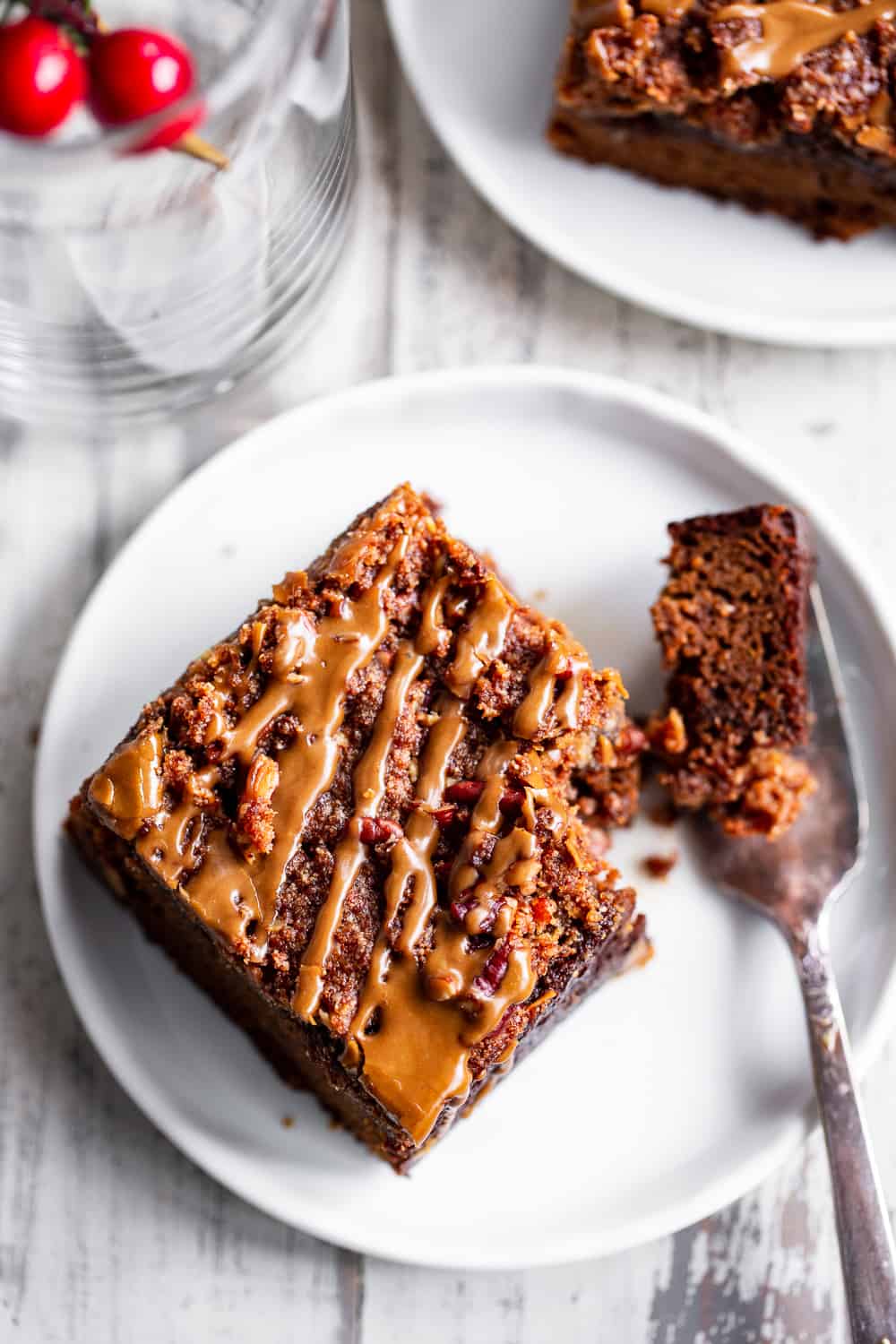 This Paleo Pumpkin Gingerbread Coffee Cake has it all!  Moist cake with sweet warm pumpkin spices and molasses topped with an addicting crumb topping and gingerbread icing!  Fancy enough to serve to guests but so delicious that you’ll want to have some to snack on all season long.