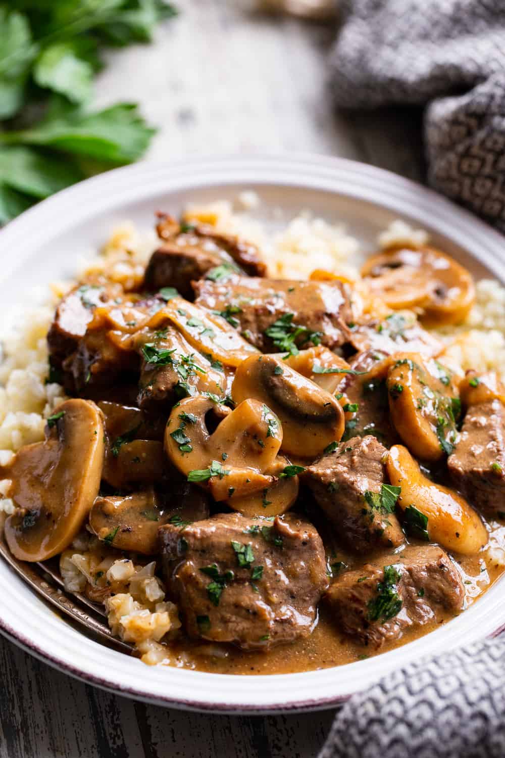 This hearty and savory paleo beef stroganoff is made all in one skillet for a quick, delicious and cozy weeknight meal.  It’s Whole30 compliant, low carb and keto and perfect served over sautéed cauliflower rice or your favorite veggie noodles! #paleo #whole30 #cleaneating #keto #lowcarb