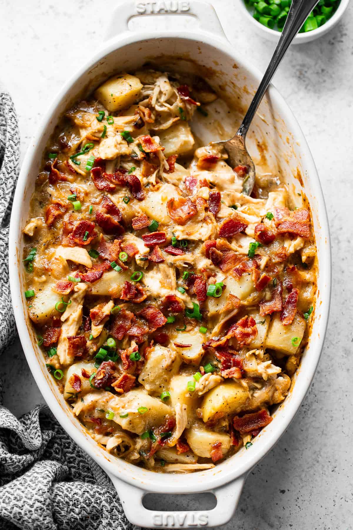 Overhead view of dairy-free chicken and potato casserole with crispy bacon